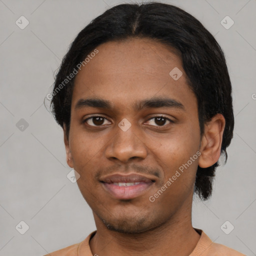 Joyful black young-adult male with short  black hair and brown eyes