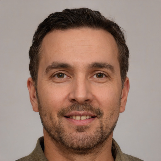 Joyful white adult male with short  brown hair and brown eyes