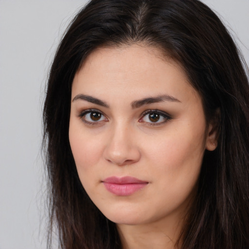 Joyful white young-adult female with long  brown hair and brown eyes