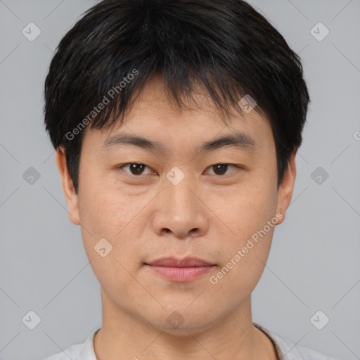 Joyful asian young-adult male with short  brown hair and brown eyes