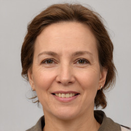 Joyful white adult female with medium  brown hair and grey eyes