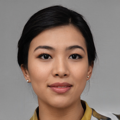 Joyful asian young-adult female with medium  black hair and brown eyes