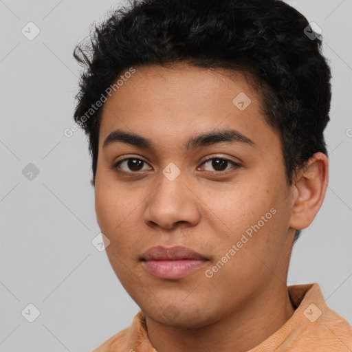 Joyful latino young-adult male with short  black hair and brown eyes