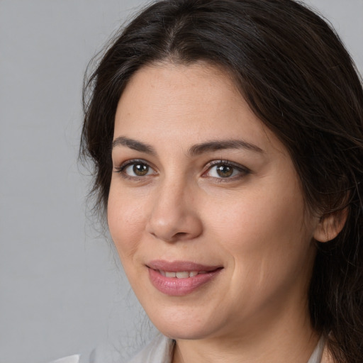 Joyful white young-adult female with medium  brown hair and brown eyes