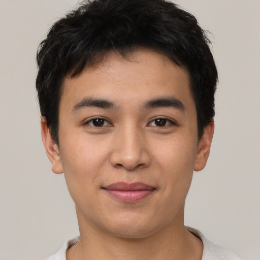Joyful asian young-adult male with short  brown hair and brown eyes