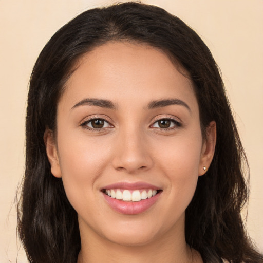 Joyful white young-adult female with long  brown hair and brown eyes