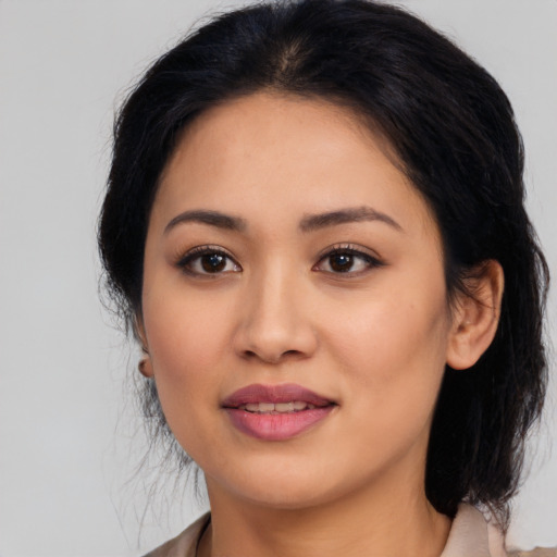 Joyful latino young-adult female with medium  black hair and brown eyes