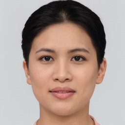 Joyful asian young-adult female with short  black hair and brown eyes