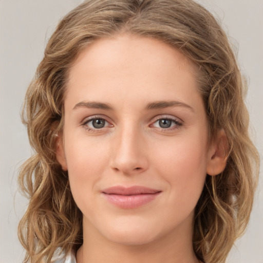 Joyful white young-adult female with medium  brown hair and green eyes