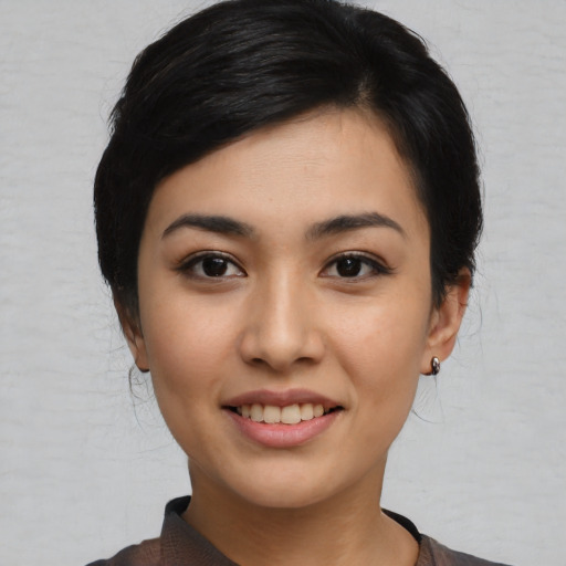 Joyful asian young-adult female with medium  black hair and brown eyes