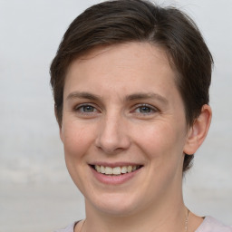 Joyful white young-adult female with short  brown hair and grey eyes