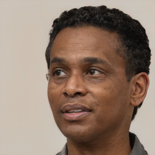 Neutral black adult male with short  black hair and brown eyes