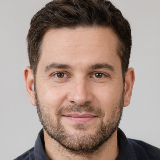 Joyful white adult male with short  brown hair and brown eyes