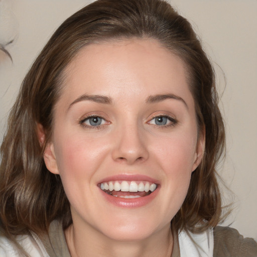 Joyful white young-adult female with medium  brown hair and blue eyes