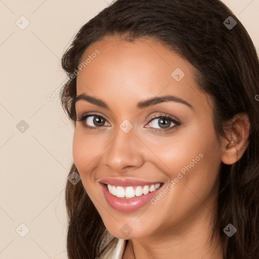 Joyful white young-adult female with long  brown hair and brown eyes