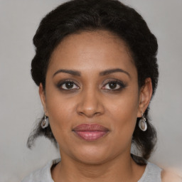 Joyful black young-adult female with medium  brown hair and brown eyes
