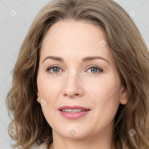 Joyful white young-adult female with medium  brown hair and green eyes