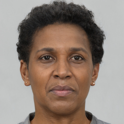 Joyful black adult female with short  brown hair and brown eyes