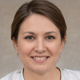 Joyful white adult female with medium  brown hair and brown eyes