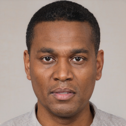 Neutral black young-adult male with short  black hair and brown eyes