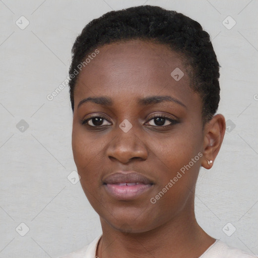 Joyful black young-adult female with short  black hair and brown eyes