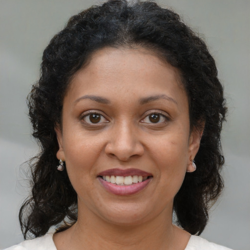 Joyful black young-adult female with medium  brown hair and brown eyes
