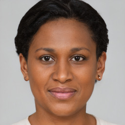 Joyful black young-adult female with short  brown hair and brown eyes