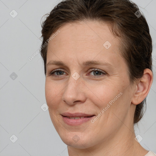 Joyful white adult female with short  brown hair and brown eyes