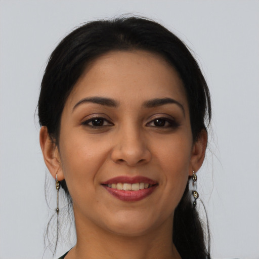 Joyful latino young-adult female with long  brown hair and brown eyes