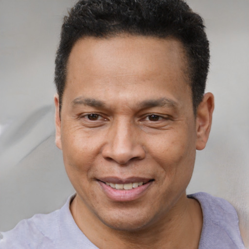 Joyful latino adult male with short  brown hair and brown eyes
