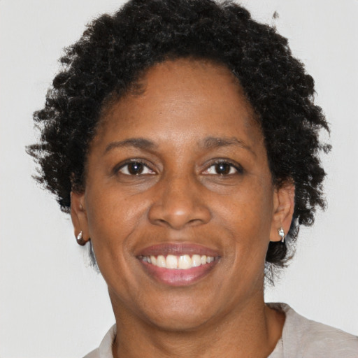 Joyful black adult female with short  brown hair and brown eyes
