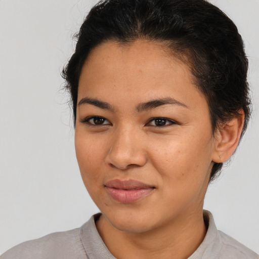 Joyful asian young-adult female with short  brown hair and brown eyes