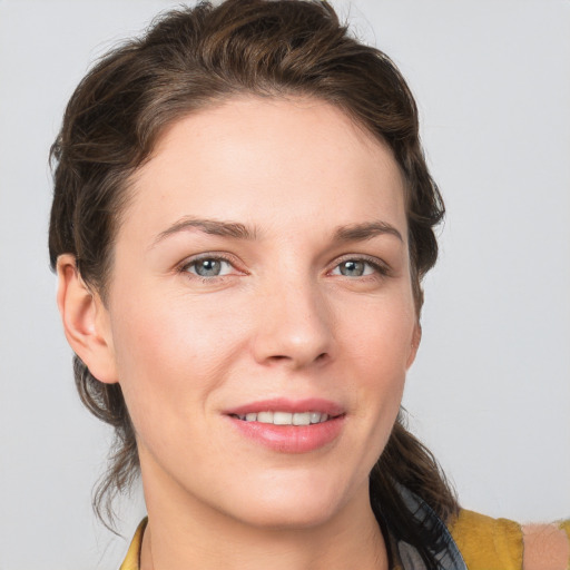 Joyful white young-adult female with medium  brown hair and grey eyes