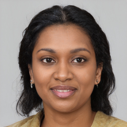 Joyful black young-adult female with long  black hair and brown eyes