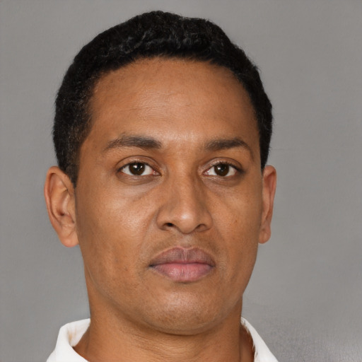 Neutral latino adult male with short  brown hair and brown eyes
