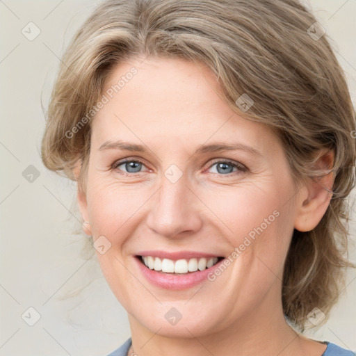 Joyful white young-adult female with medium  brown hair and blue eyes