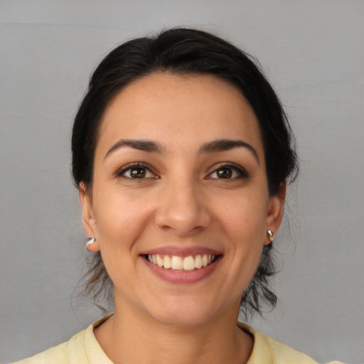 Joyful white young-adult female with medium  black hair and brown eyes