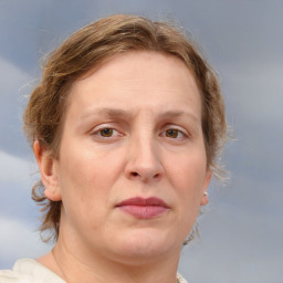 Joyful white adult female with medium  brown hair and blue eyes