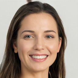 Joyful white young-adult female with long  brown hair and grey eyes