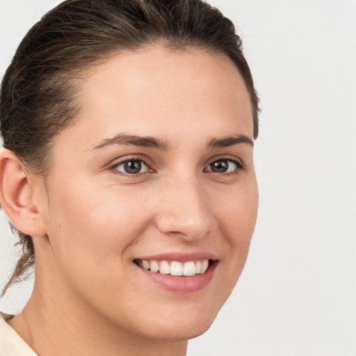 Joyful white young-adult female with medium  brown hair and brown eyes