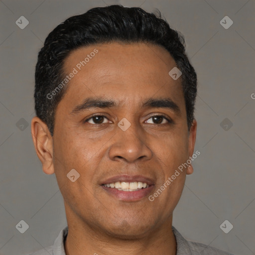 Joyful latino adult male with short  black hair and brown eyes