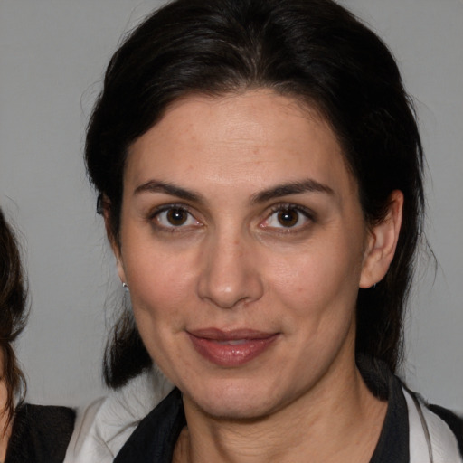 Joyful white adult female with medium  brown hair and brown eyes