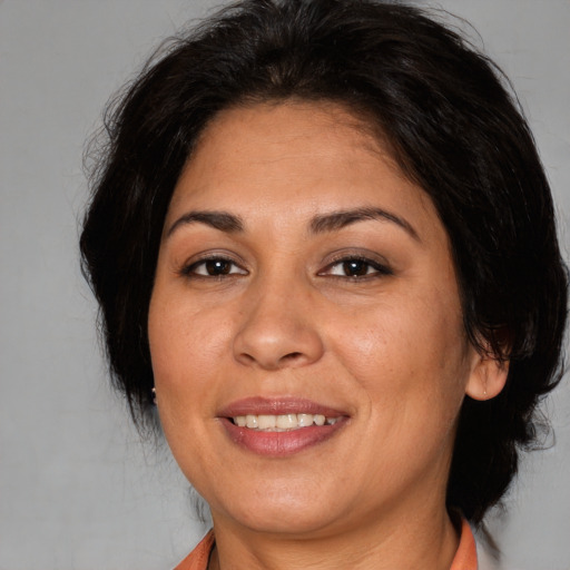 Joyful white adult female with medium  brown hair and brown eyes
