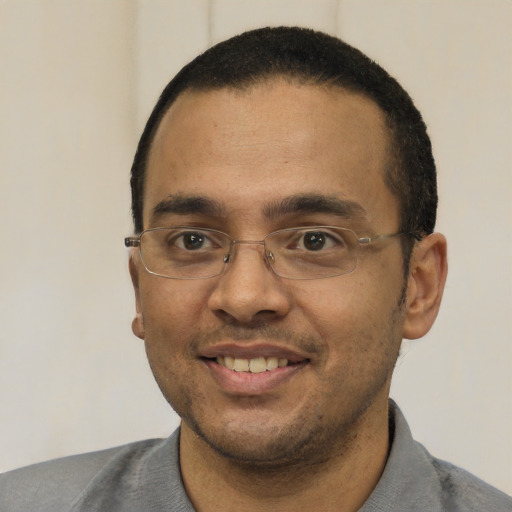 Joyful white adult male with short  black hair and brown eyes