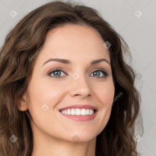 Joyful white young-adult female with long  brown hair and green eyes