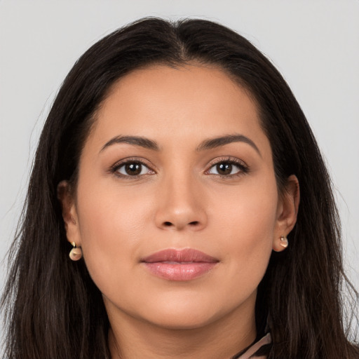 Joyful latino young-adult female with long  brown hair and brown eyes