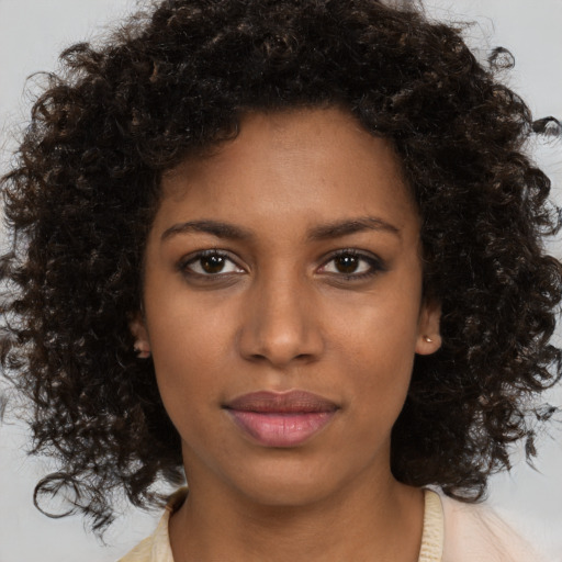 Joyful black young-adult female with medium  brown hair and brown eyes