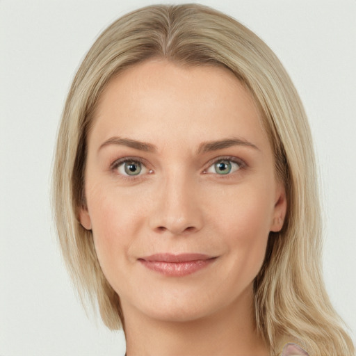 Joyful white young-adult female with long  brown hair and blue eyes