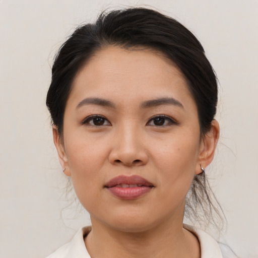 Joyful asian young-adult female with medium  black hair and brown eyes