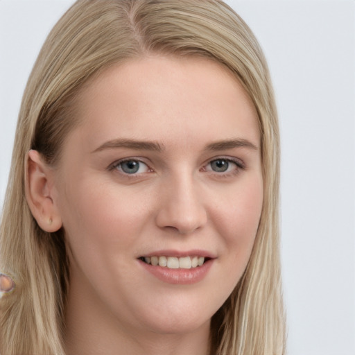 Joyful white young-adult female with long  brown hair and blue eyes